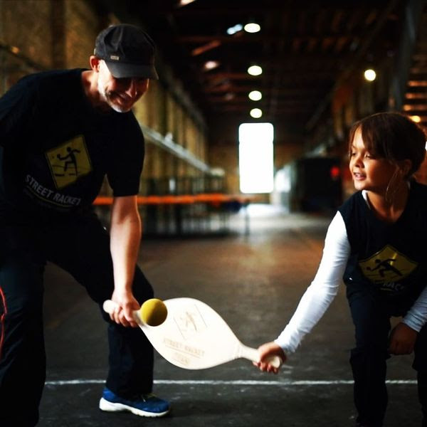 Two people playing pickel ball